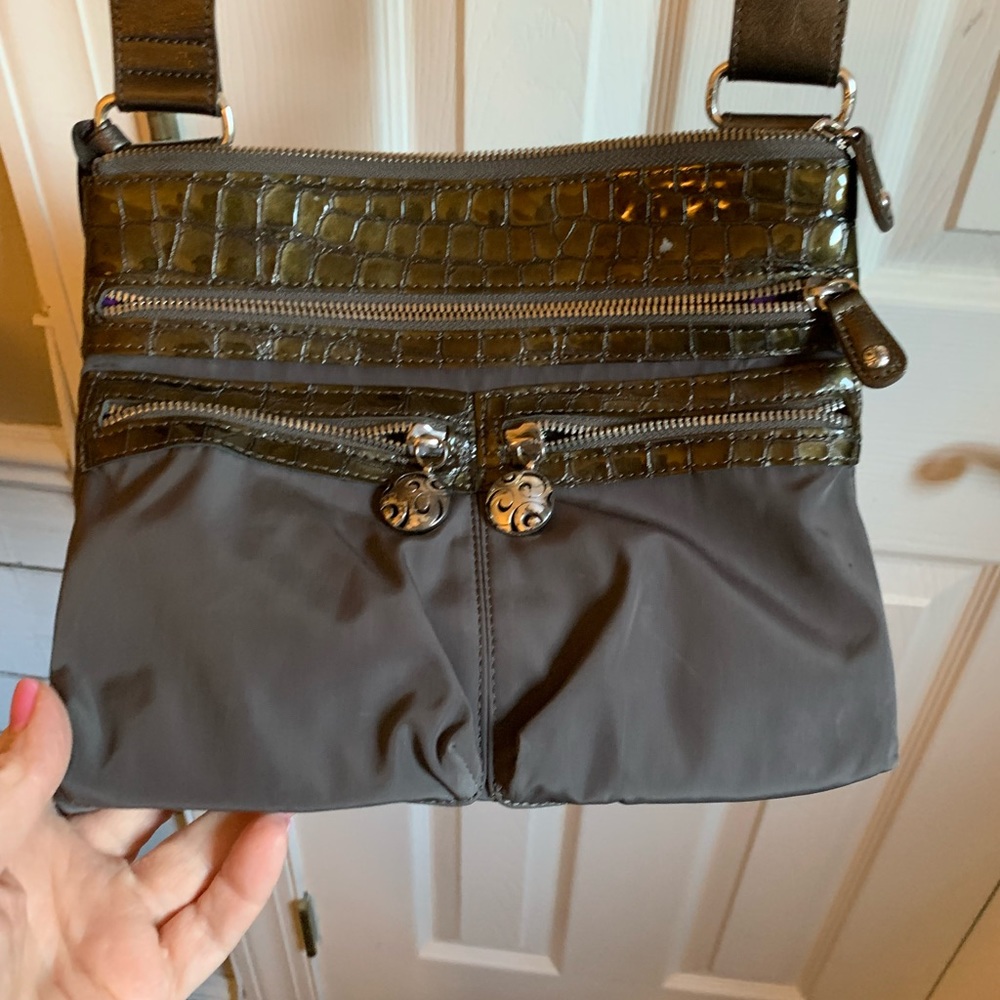 Brighton cross body bag. Grey exterior with a purple patterned interior.